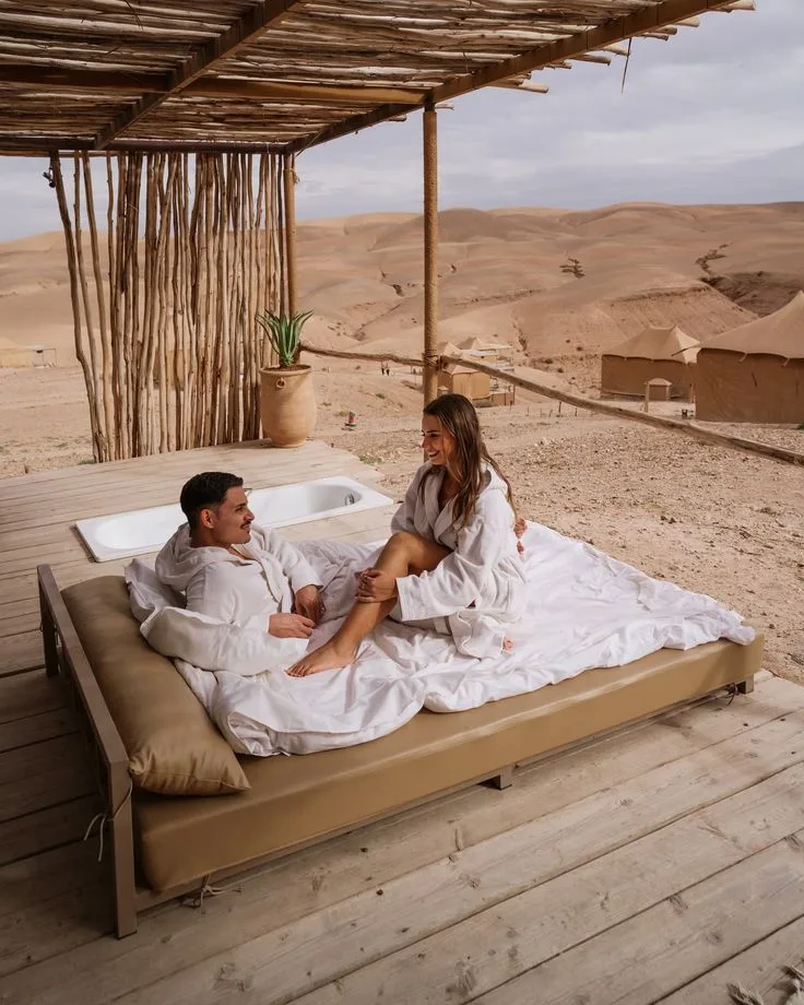Couple relaxing on an outdoor bed in the Agafay Desert