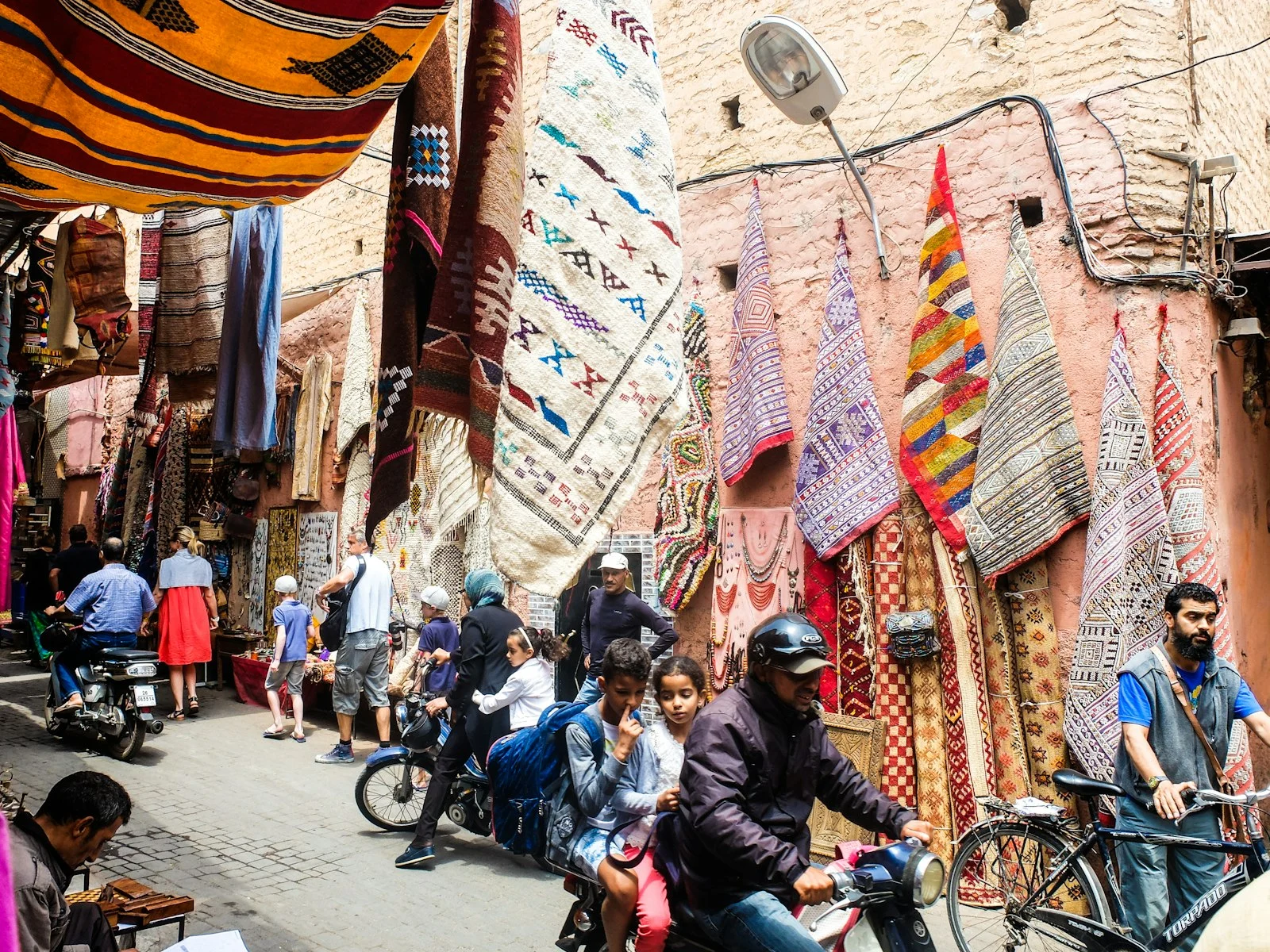 Busy street with scooters in the Marrakech medina Busy street with scooters in the Marrakech medina