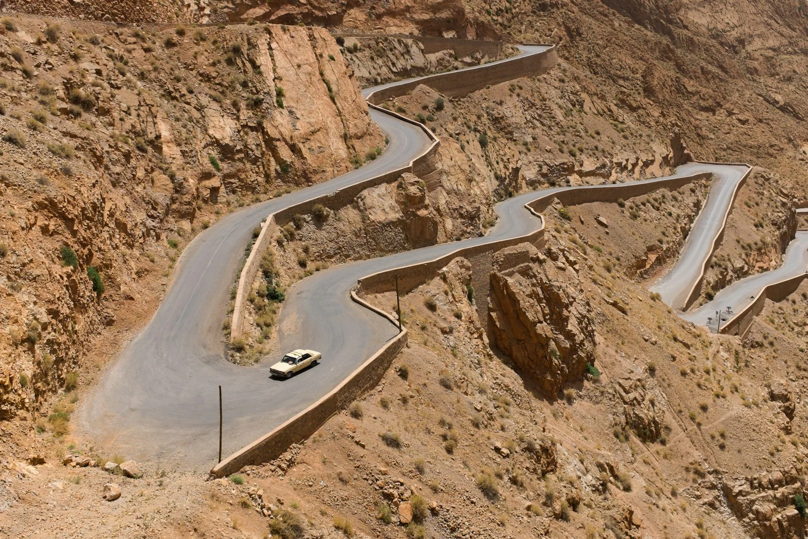 Car on the hairpin bends of a Moroccan mountain road