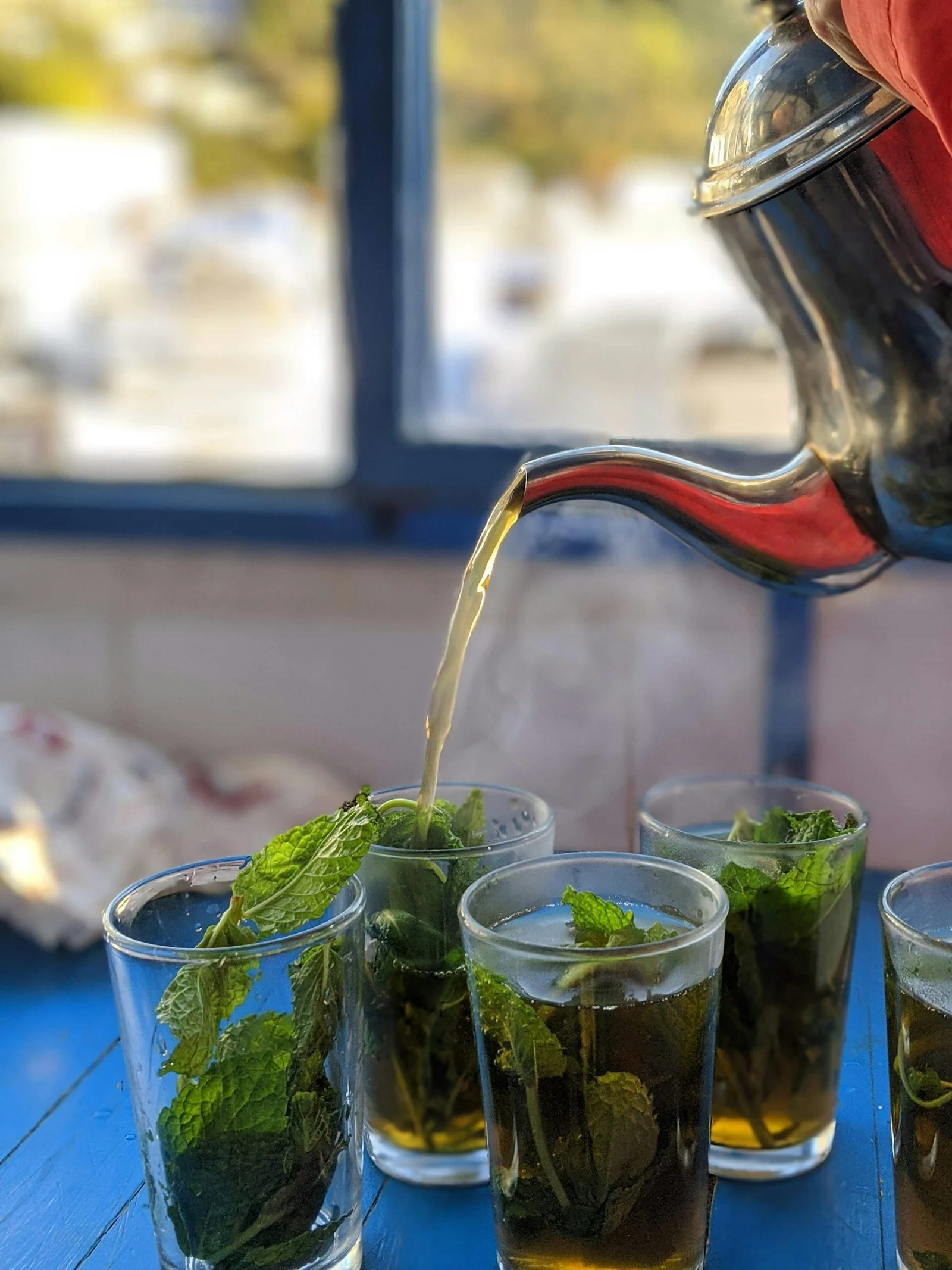 Pouring Moroccan mint tea from a height