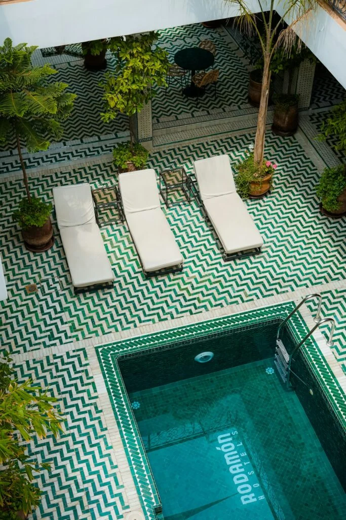 Tiled pool and loungers in a luxury riad