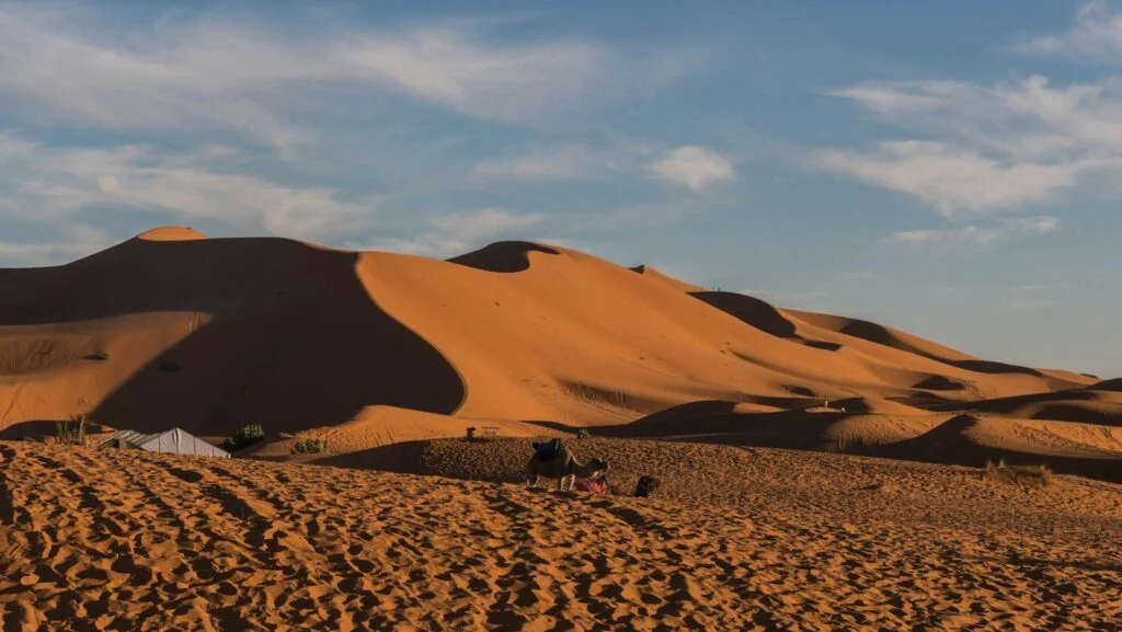 Agafay Desert vs Sahara Desert: Which One Should You Choose? 1 Sand dunes of the Erg Chebbi near a desert camp